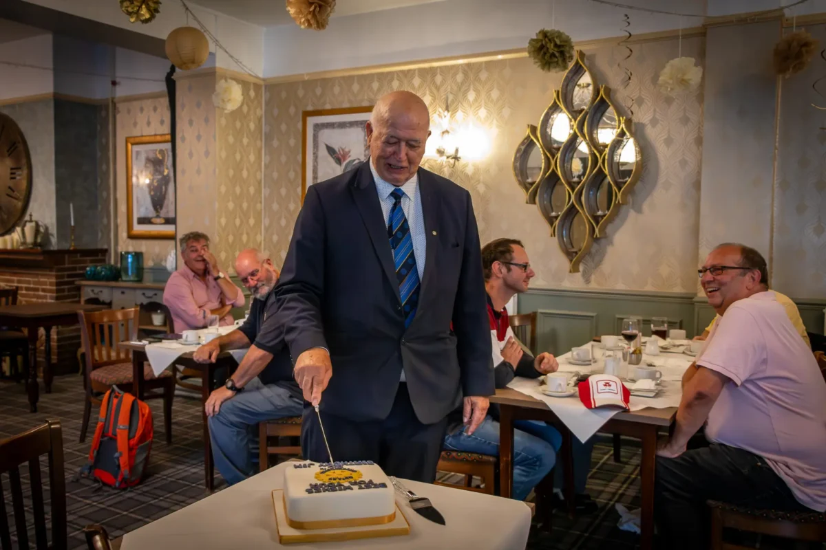 Rotarian Jim Needley Cutting His Cake